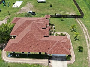 Red shingle roof replacement for single-story home in Pharr, TX — XYZ Roofing and Restorations.