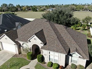 Luxury residential roof replacement with multi-tone shingles in Weslaco, Texas.