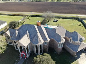 Hail damage roof repair and re-shingling on large home in San Benito, TX.