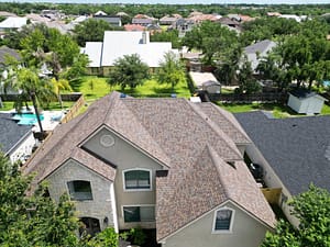 Roofing project on two‑story home with brown shingles in Harlingen, TX