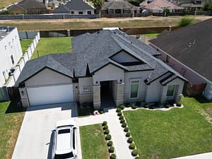 Modern home with gray shingle roof replacement in Brownsville, TX