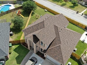 Two‑story home roof repair using laminated shingles in Harlingen area