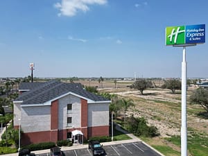 Repaired shingle roof on two-story suburban home after storm damage in Raymondville, Texas.