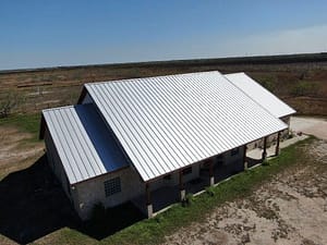 Metal roof installation on ranch-style home outside Brownsville, TX by XYZ Roofing experts